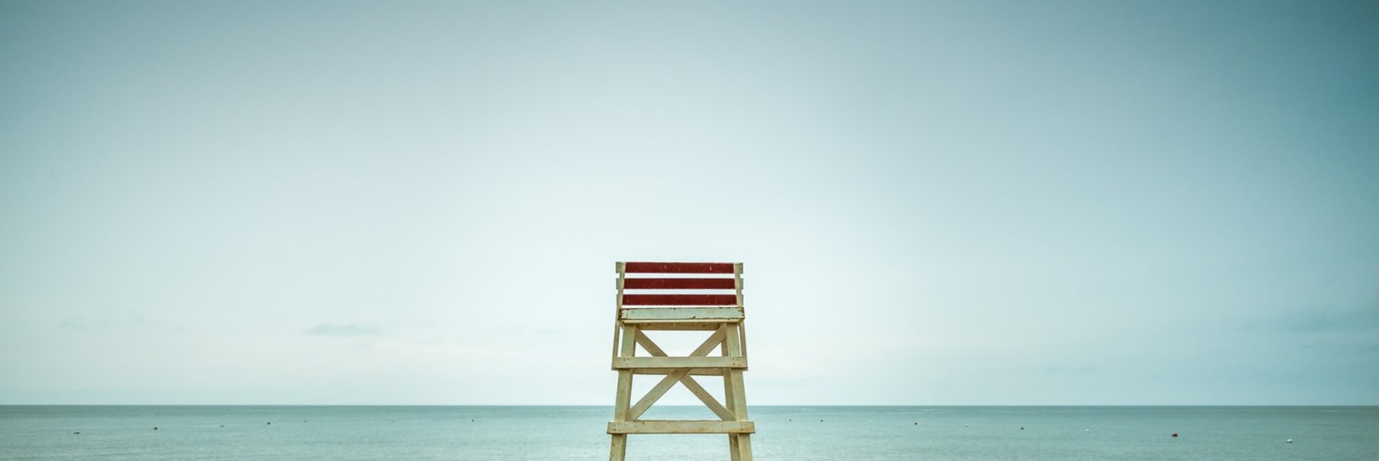 beige wooden lifeguard seat on shore